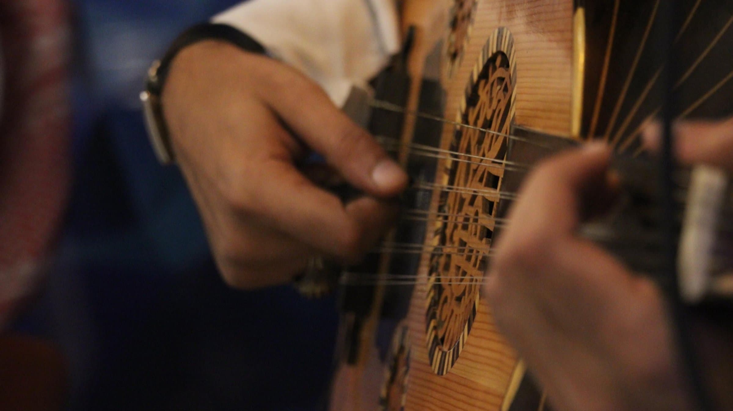 Strumming soulful melodies on the oud, capturing the essence of traditional music and artistry.