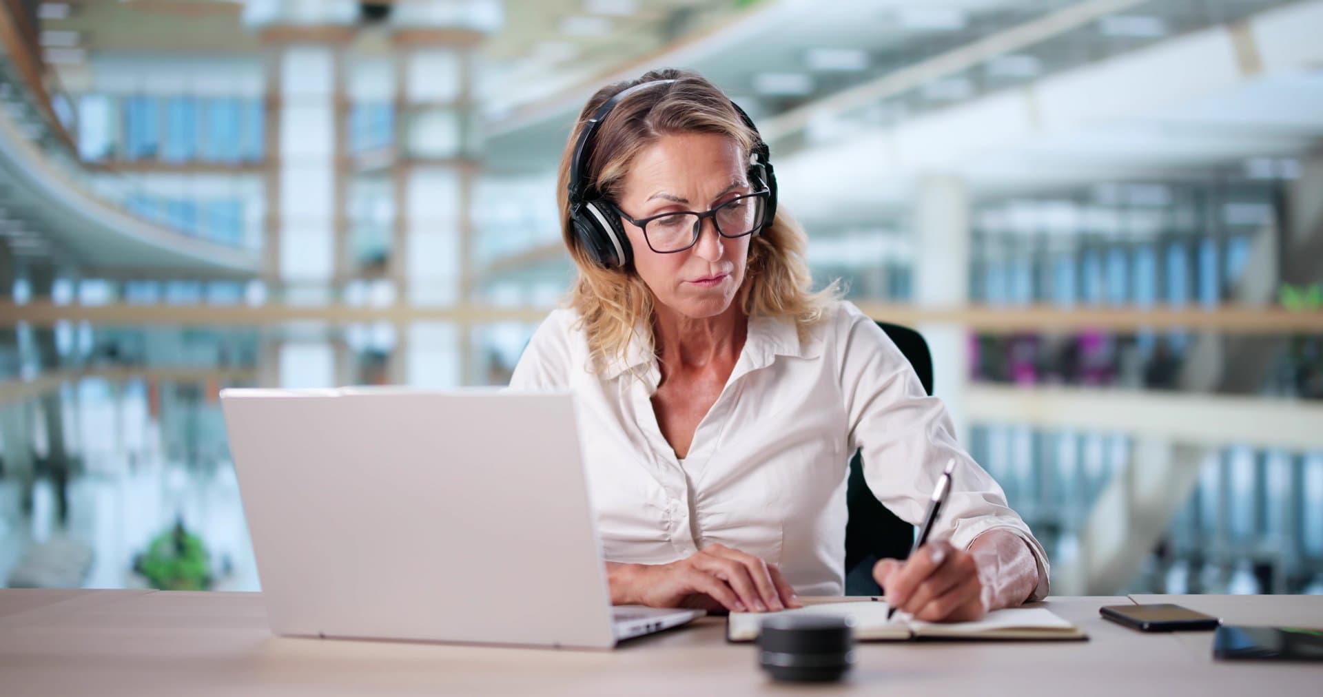 Woman Studying Online On Laptop Computer With Headphones